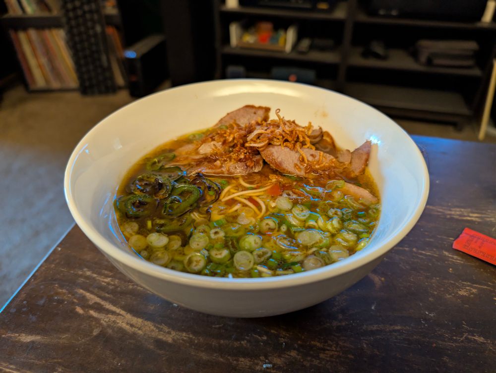 A bowl of pork and scallion ramen.