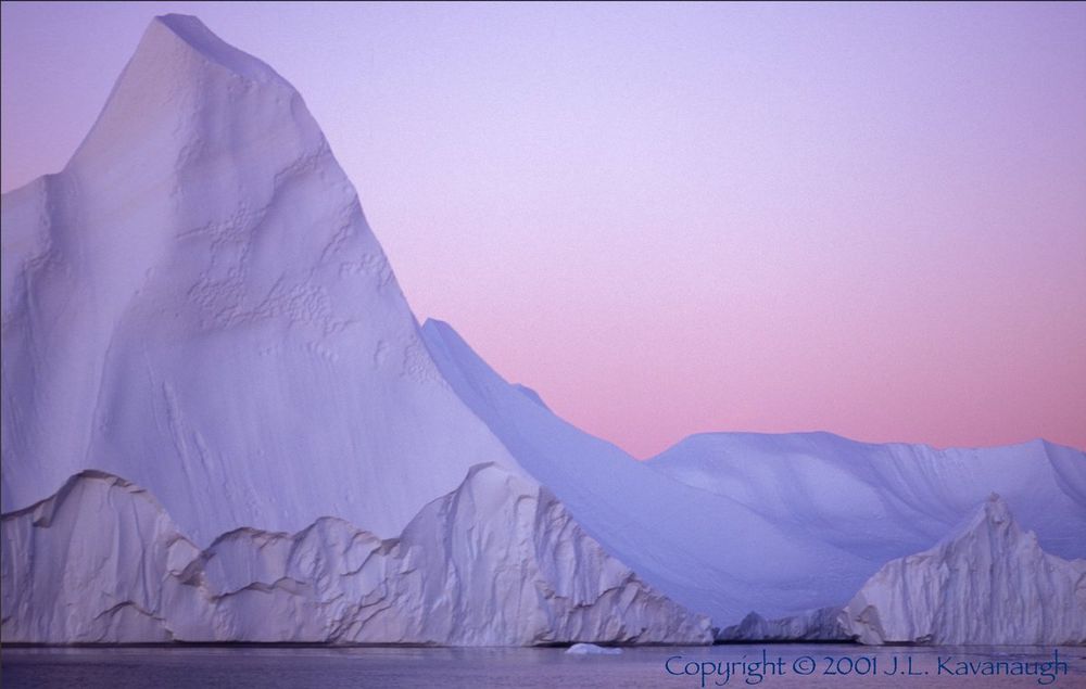 An iceberg on the water in loaming light. Ilulissat, Greenland.