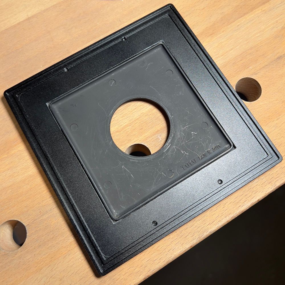 Rear view of lensboard adapter, with Toyo Field lensboard in place. Prior to the modifications, the Toyo board didn’t quite fit given the tighter radius of the its raised light trap.  