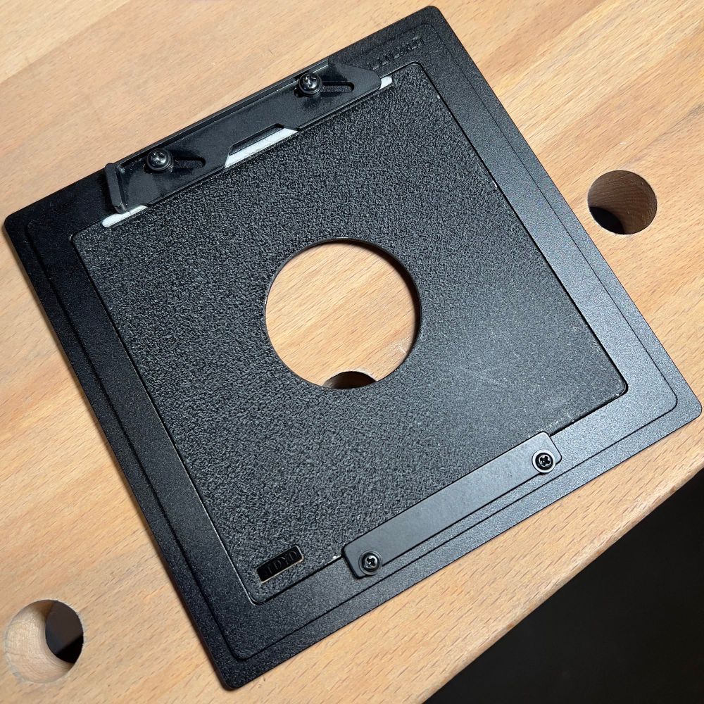 Front view of lensboard adapter, with Toyo Field lensboard in place. Prior to the modifications, the Toyo board didn’t quite fit given the tighter radius of the its raised light trap.  