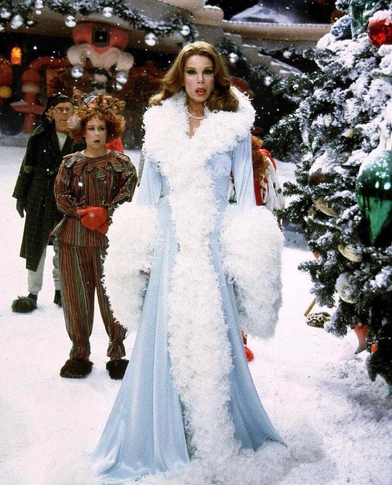 Martha May Whovier wears a blue robe with big puffy sleeves 