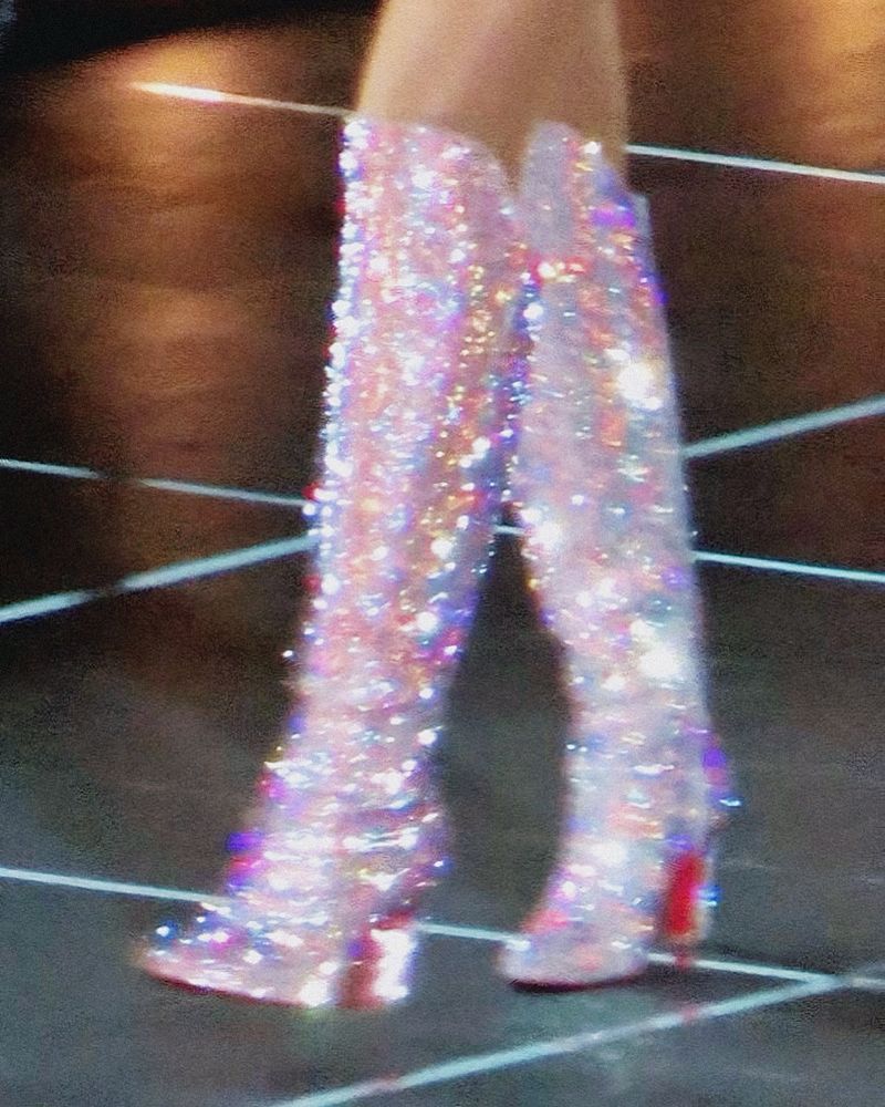 Blurry picture of Taylor swifts silver eras tour boots 