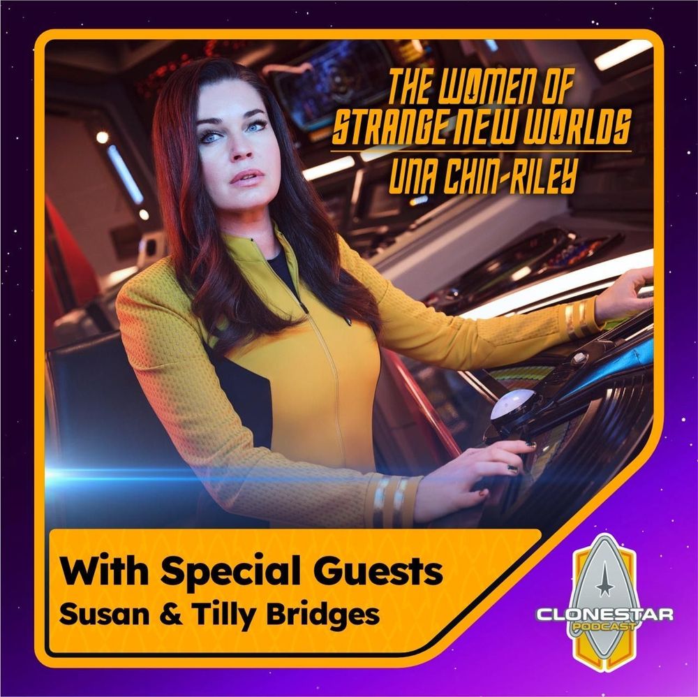 The image features a woman seated in a futuristic control room. She is wearing a yellow and black uniform with a high collar and patterned sleeves. Her right arm rests on a sleek, curved console featuring buttons and a glowing circular element, likely part of the ship’s controls. She has long, dark hair and gazes into the distance with an attentive expression. The background includes various illuminated panels and displays, contributing to the sci-fi aesthetic. The overall colors are deep with warm lighting. The image is bordered with a purple and orange frame that includes text. Alt-text: A woman in a yellow and black uniform sits at a futuristic control console with glowing panels. Transcribed Text: The Women of Strange New Worlds Una Chin-Riley With Special Guests Susan & Tilly Bridges Clonestar Podcast