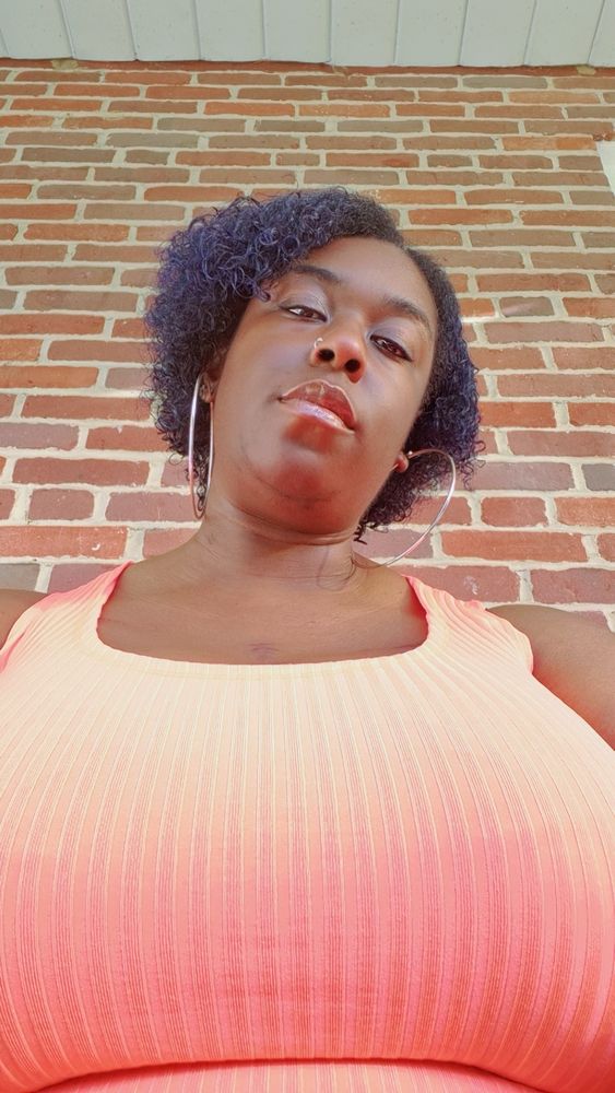Big tiity Black women in a bright orange dress
