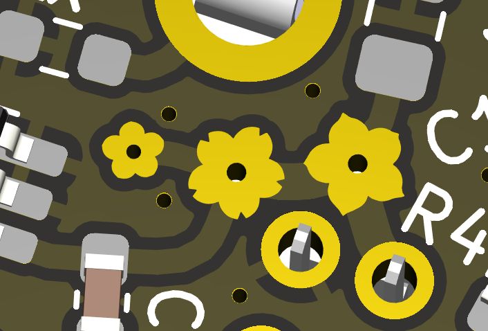 Screenshot of a closeup CAD render of a PCB design, showing a branching trace with three vias each having a different vaguely cherry blossom-esque shaped pad instead of a circular annulus