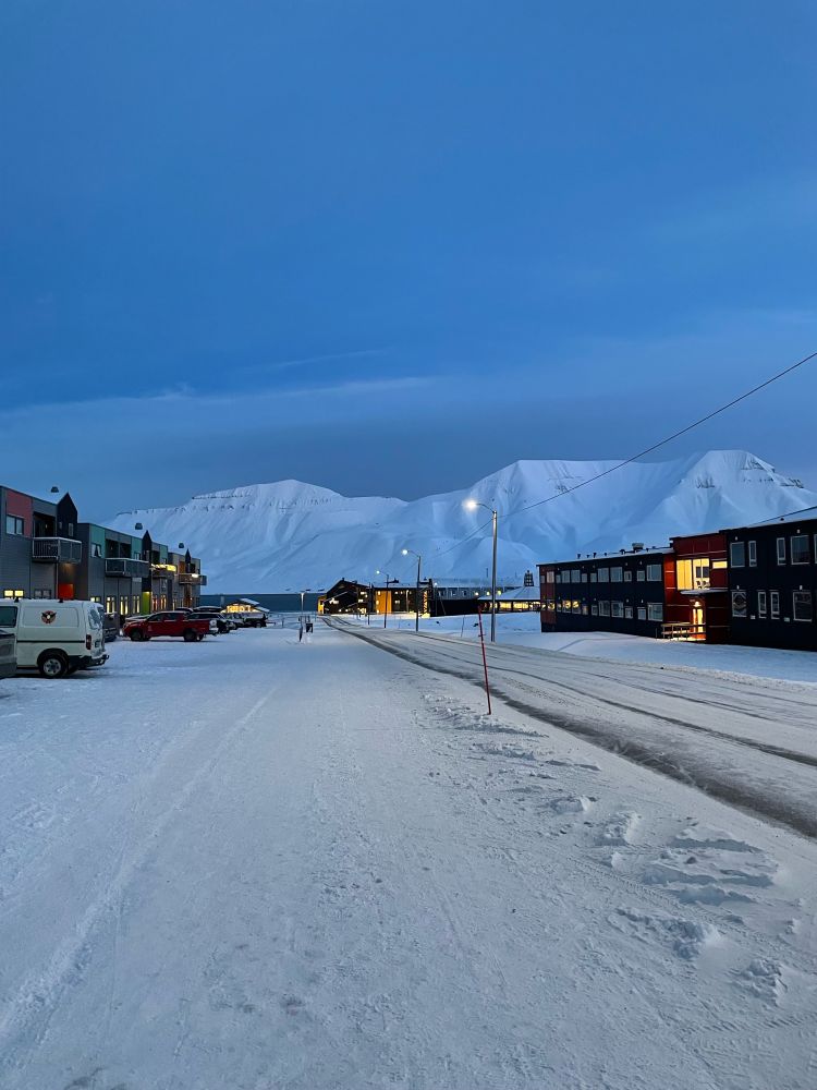A street in Longyearbyen at 11am with blue light.