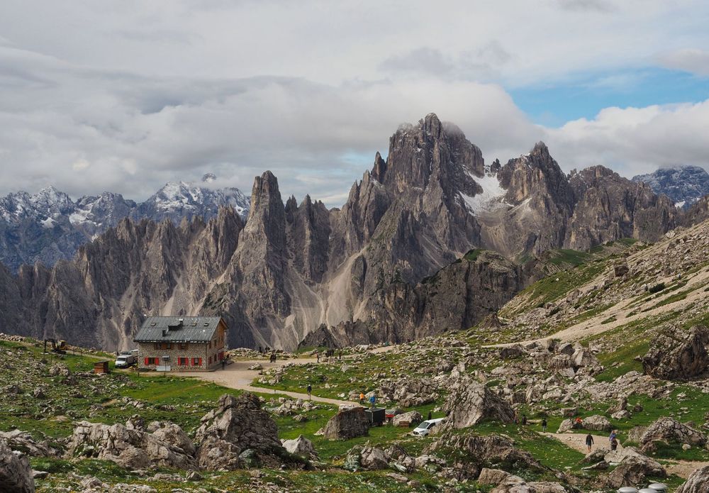 A refuge dwarfed by huge mountains in northern Italy
