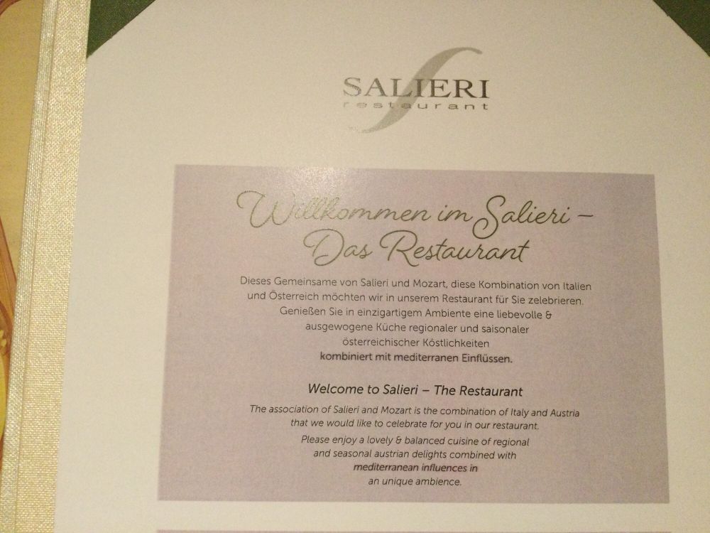 Description in German and English for an
Italian-Austrian fusion restaurant in Salzburg 
that describes itself as inspired by “the association of Salieri and Mozart.”