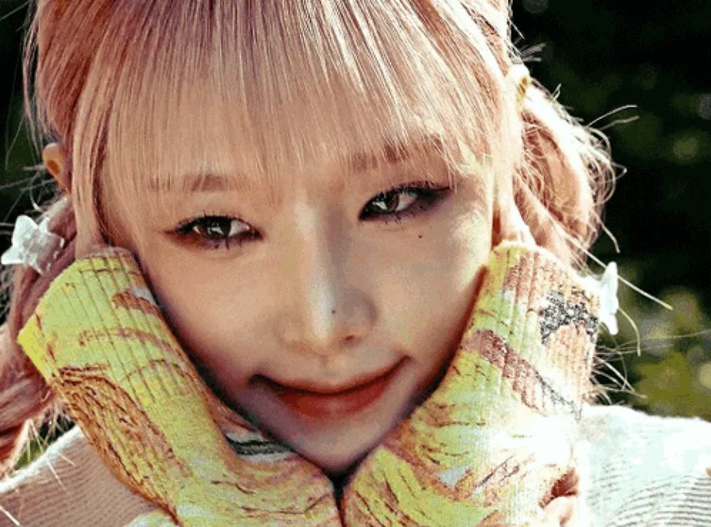 a close up of a woman 's face with a yellow scarf around her neck .