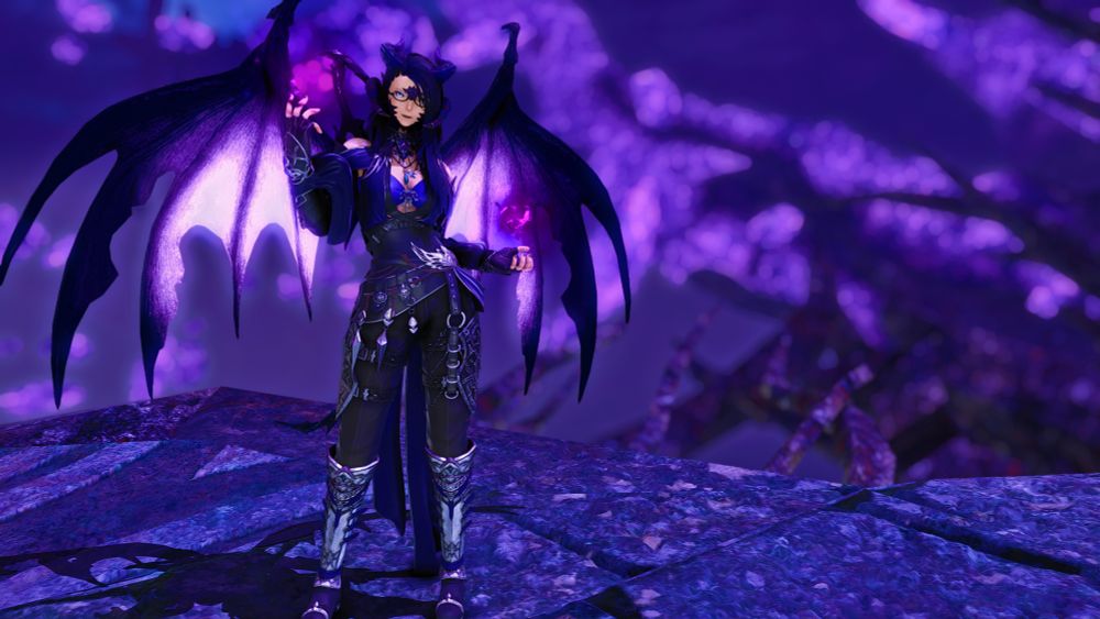 An Auri woman with black and purple wings and horns in addition to her normal scales and horns. She looks lightly armored and ready to fight, with orbs of darkness floating over each hand.