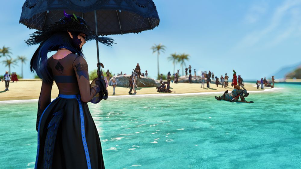 Chrys staring back at the viewer as a large group of people gather at the beach and she stands in the water.