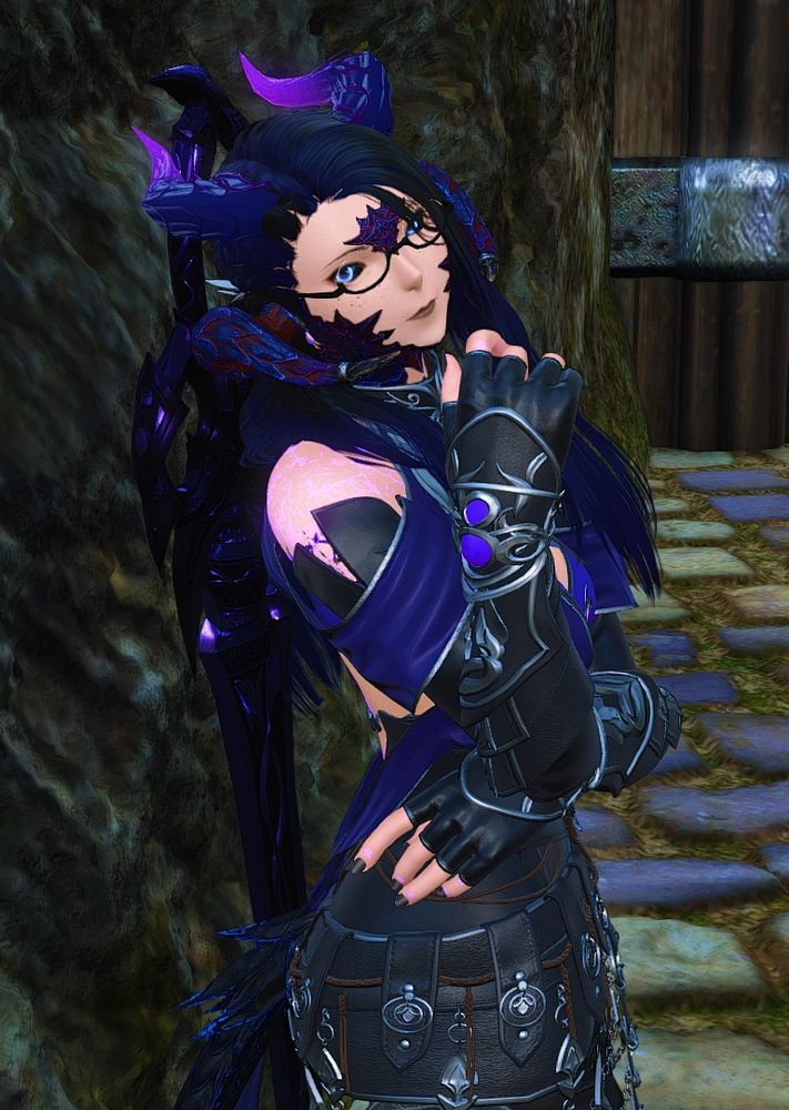 A xaela woman looking up and to the side at the camera 