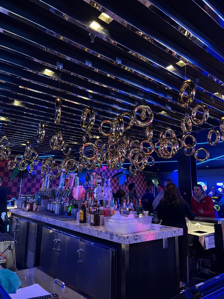 Top Golf bar with a ton of gold rings above it 