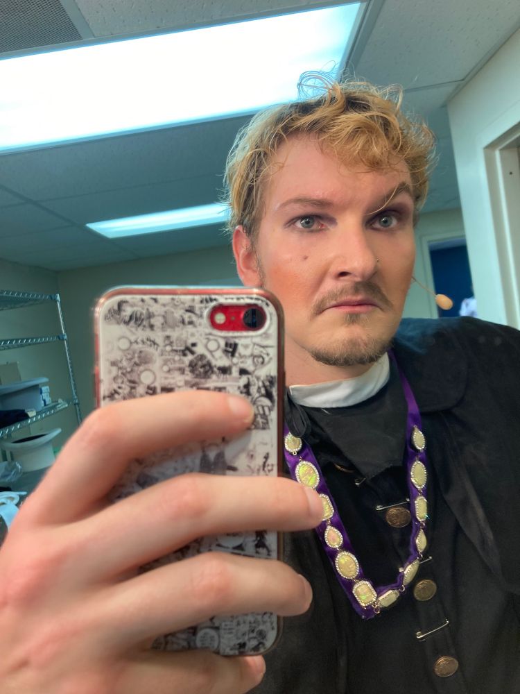 I am standing in front of a mirror dressed as my character, John Jasper, for a musical. He is dressed in Victorian steampunk attire and vaudevillian makeup, this image is a closeup to emphasize the makeup.