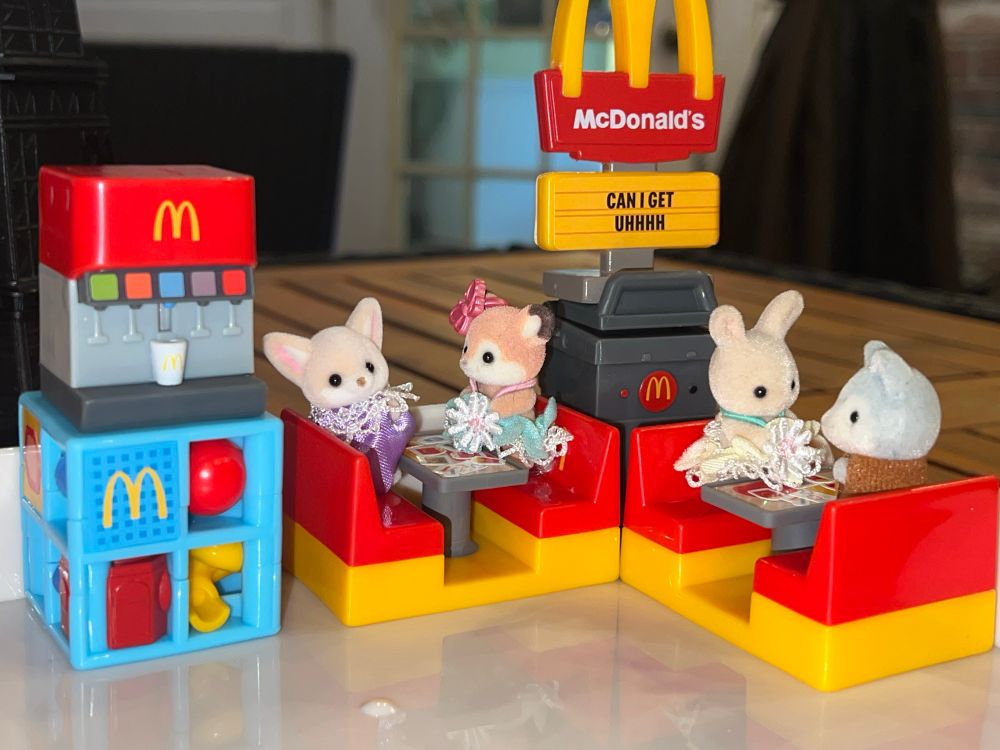 lil mcdonald’s happy meal tots arranged to look like a restaurant, baby calico critters are patrons of this establishment