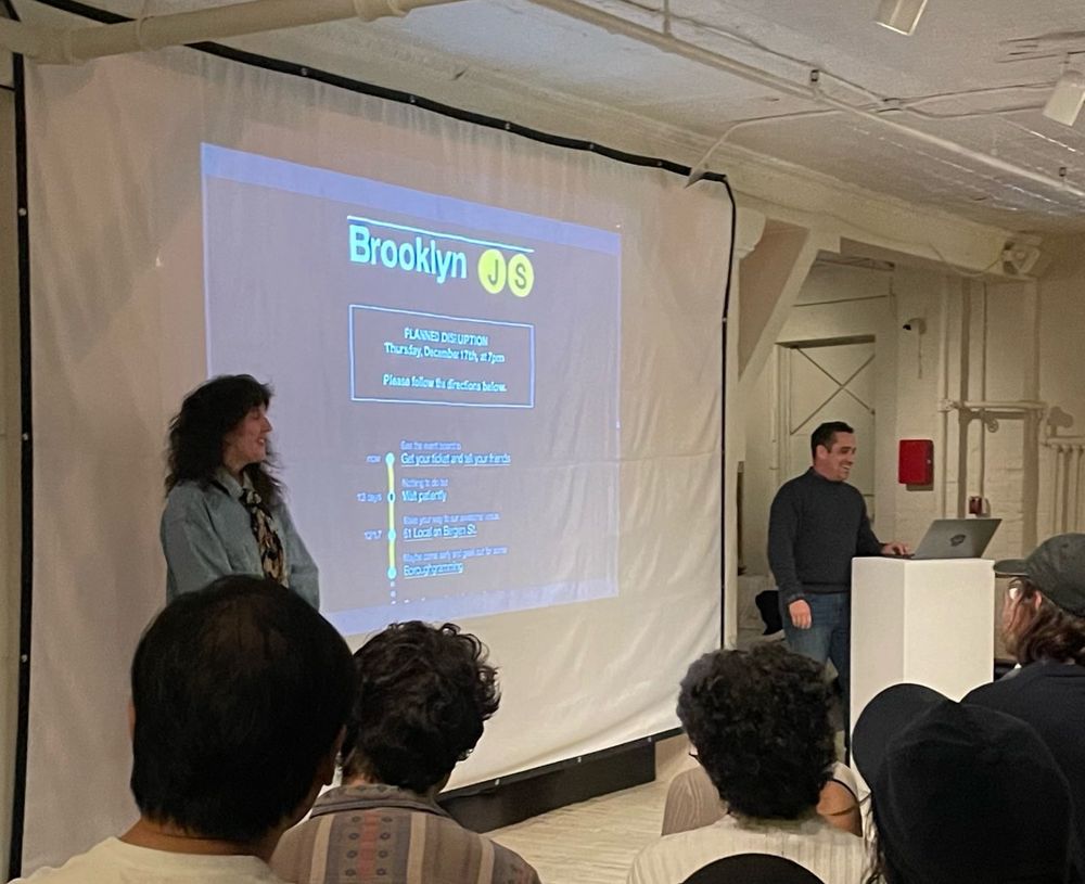 Picture of a slide being presented with a screenshot of the old BrooklynJs website 
