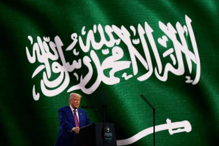 Trump at conference in Middle East in front of Saudi flag