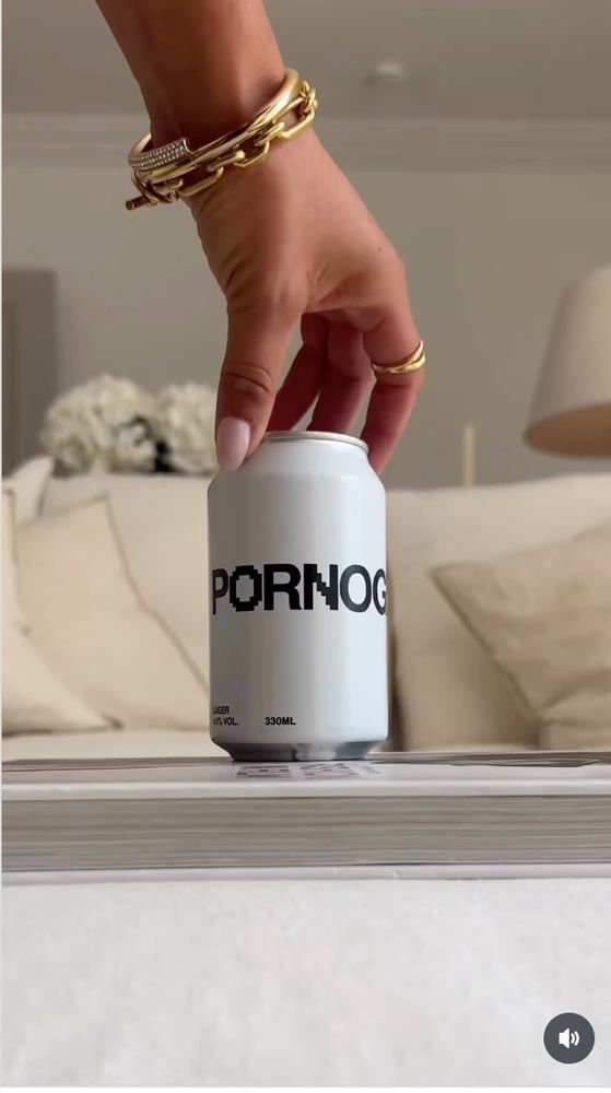 White can of beer labeled "Pornography" on a table