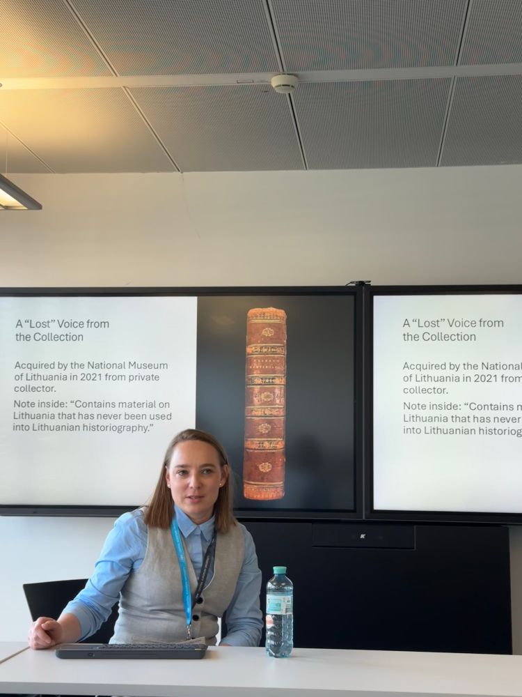 A speaker presenting at an academic conference.