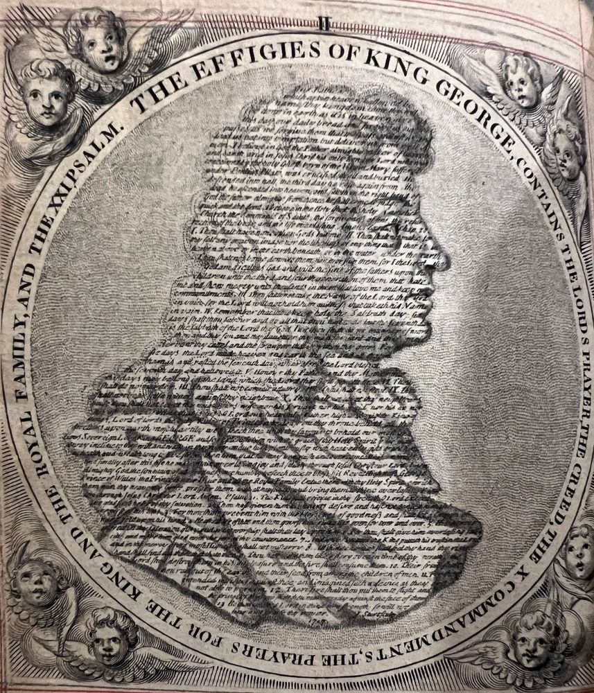An engraved portrait of King George I composed entirely of tiny printed text forming his facial features, hair, and clothing. The circular border around the portrait reads: “THE EFFIGIES OF KING GEORGE CONTAINS THE LORD’S PRAYER, THE CREED AND THE X COMMANDMENTS, THE PRAYERS FOR THE KING AND THE ROYAL FAMILY, AND THE XXI PSALM.”