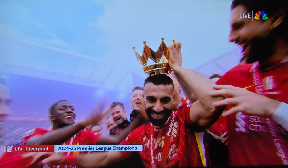 Screenshot of Mo Salah being crowned with the top of the PL trophy