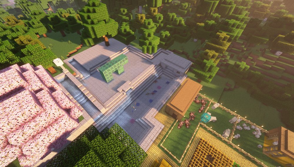 A screenshot of minecraft, showing off a water feature and a green copper statue of a pig