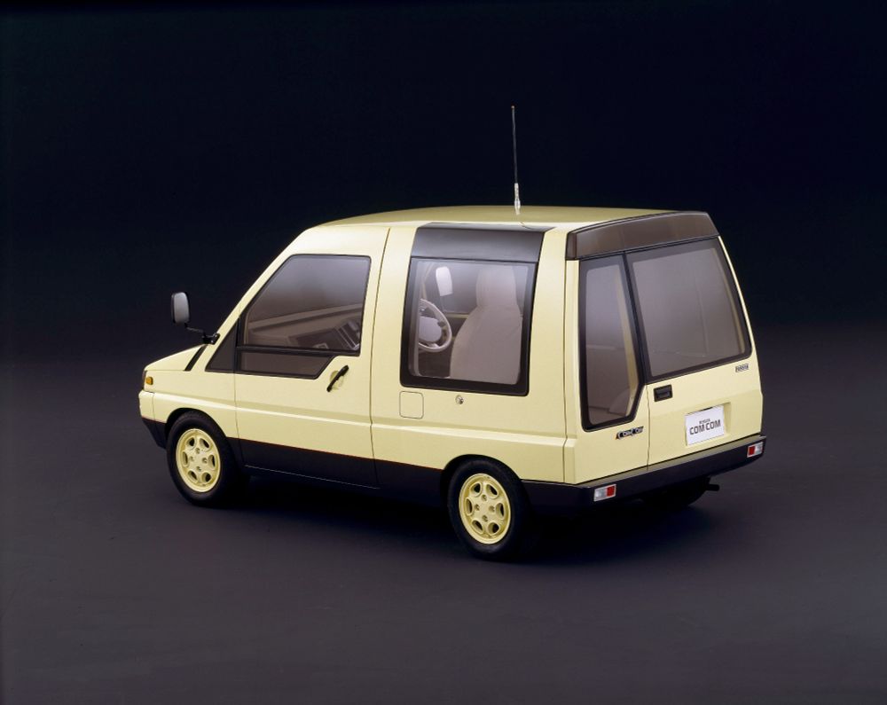 the 1985 Nissan Com Com concept car. it's a small light yellow van with a boxy shape and large windows