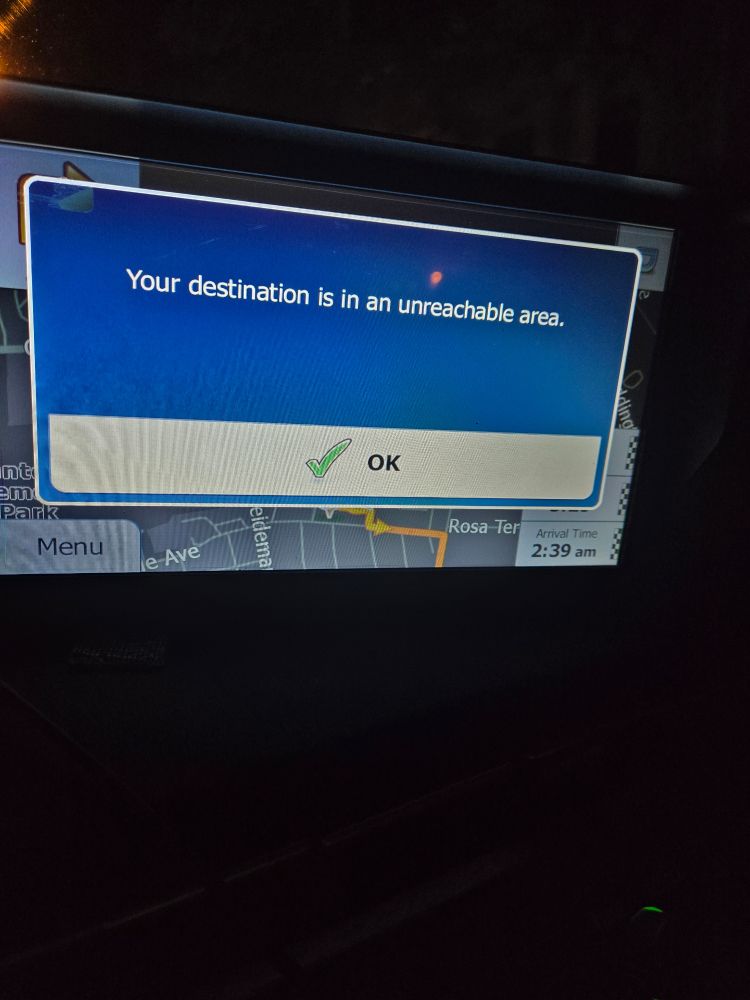 A GPS screen reading, "Your destination is in an unreachable area." With an OK button below error message. 