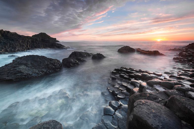 Photographic image of sundown over Giants Causeway landscape, North Ireland coast.