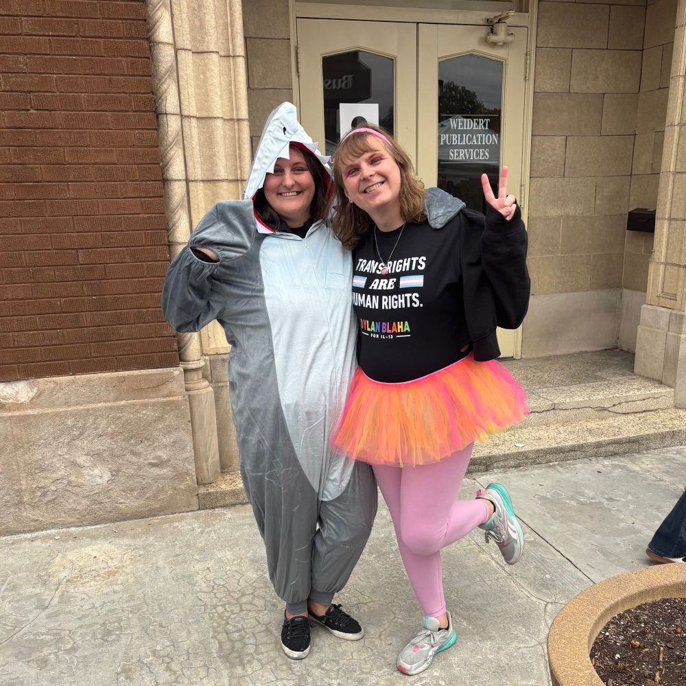 A photo of Tori in a tutu and her wife dressed as a shark. 