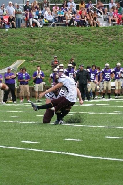 A picture of Tori kicking a football in college.