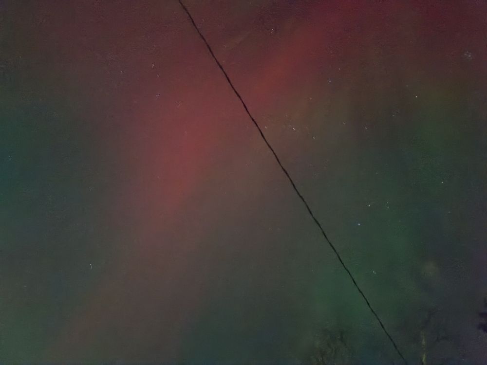 A view of the Northern Lights from my house in Superior, Wisconsin just before 11 p.m. on November 11, 2025.  This was taken through the night vision setting on my phone's camera.
