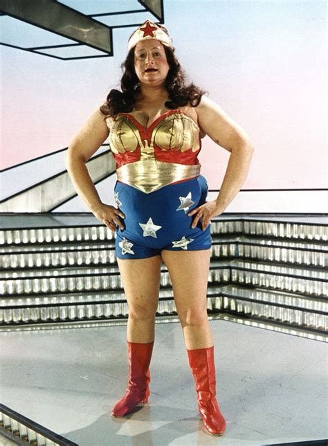 An older overweight lady is dressed as Wonder Woman. 
