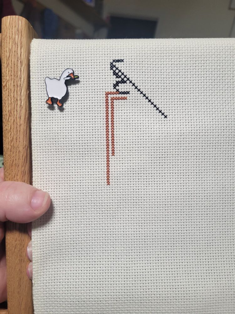 First stitches in. The Folly Tree by Long Dog Samplers. Goose with knife needleminder. 