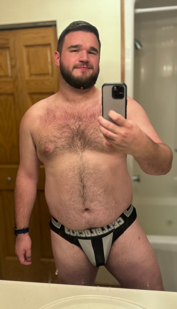 Mirror selfie of a man in black and white briefs