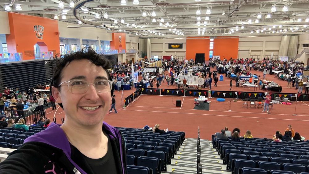 Person standing in front of science faire event hall 