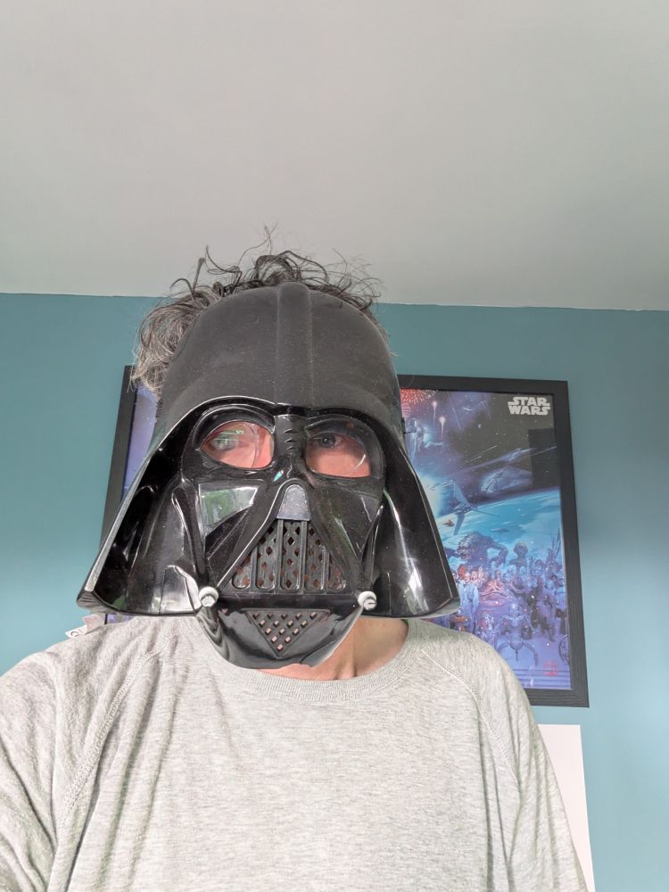 A man in a Darth Vader mask