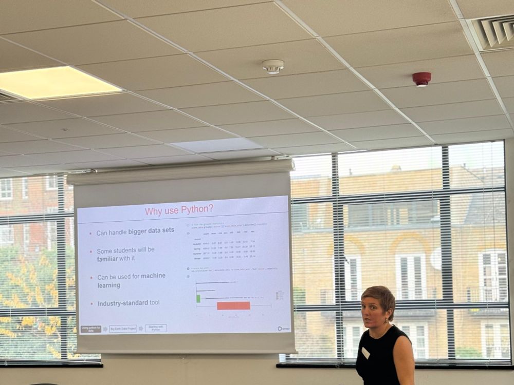 A presenter stood by a screen