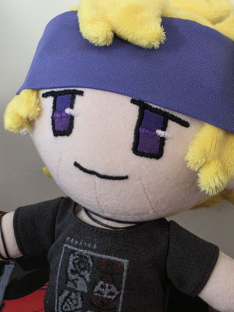 Photo of plush Morty (Rae edition), close up of his face and chokers