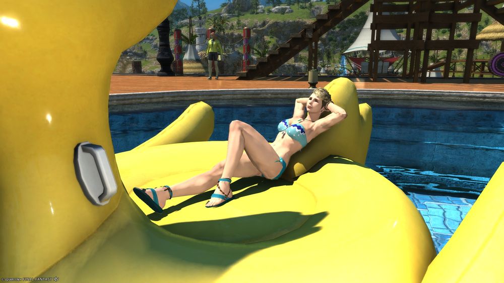 Katina in a bikini, lounging on a giant inflatable chocobo