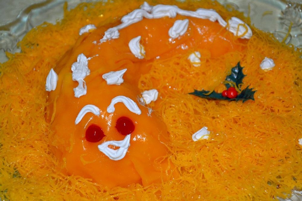 A bright yellow egg-yolk coloured mess, which partially resembles a snake with preserved cherries for eyes and spray cream mouth/scales. The Portuguese christmas cake known as "lampreia de ovo", lamprey of eggs.