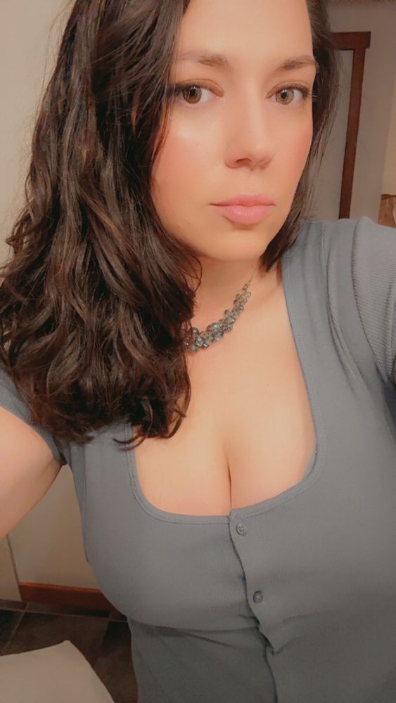 me, dark hair down, blue gray dress 