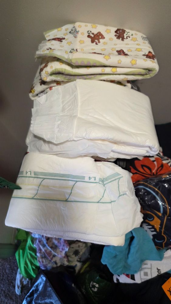 Three sets of adult-sized diapers, top to bottom Crinklz l, Northshore Megamax (white), Abena L4.