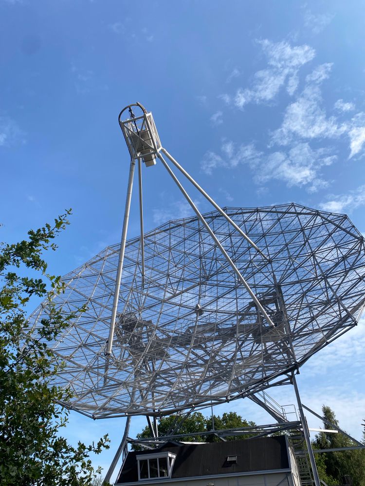 In de omgeving van Dwingeloo in het Dwingelderveld staat deze radiotelescoop de ruimte af te luisteren. Onder blauwe lucht temidden van bos en heide. 