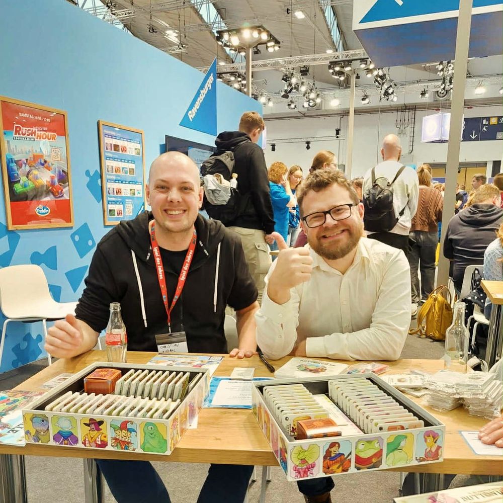 Christian and Erik signing their game The Glorious Guilds of Buttonville at the Ravensburger booth of Spiel. 