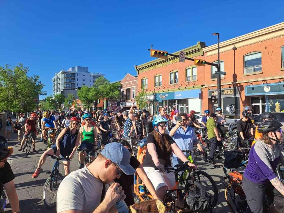 Huge group of people on bikes on a street.