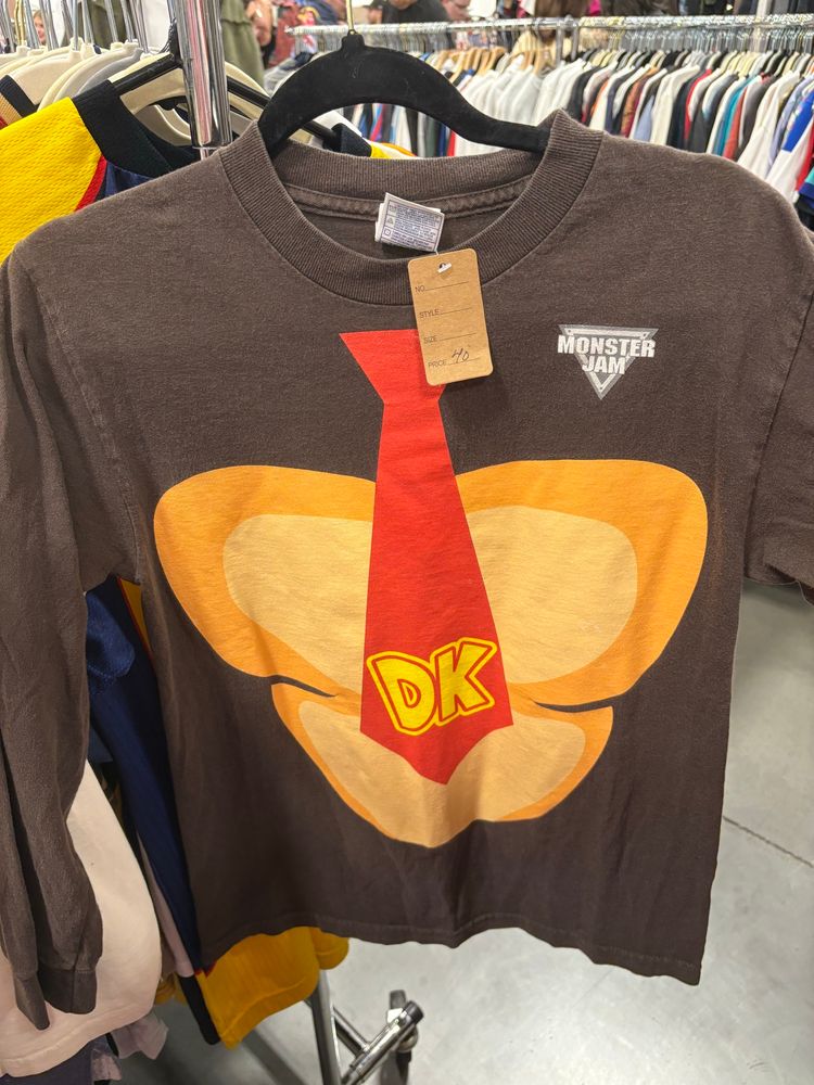 A brown shirt made to look like Donkey Kong’s chest with a monster jam logo in the upper right hand corner 