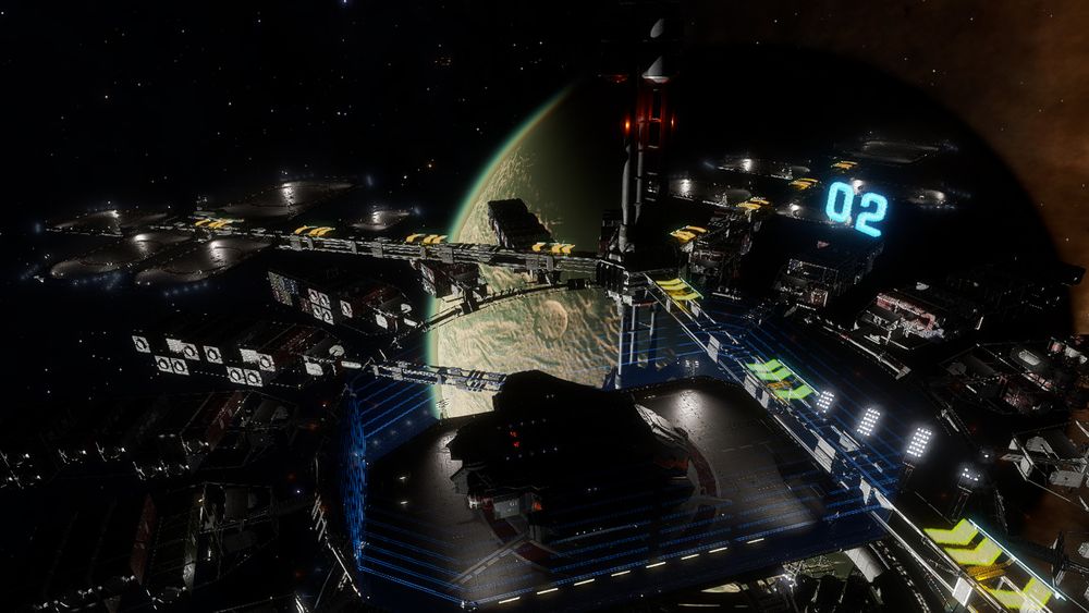 A Type-9 cargo transport sits on a landing pad at a construction site in orbit over a rocky planet. There seems to be a green haze resembling some kind of atmosphere on the planet even though the system information says it doesn't have one.