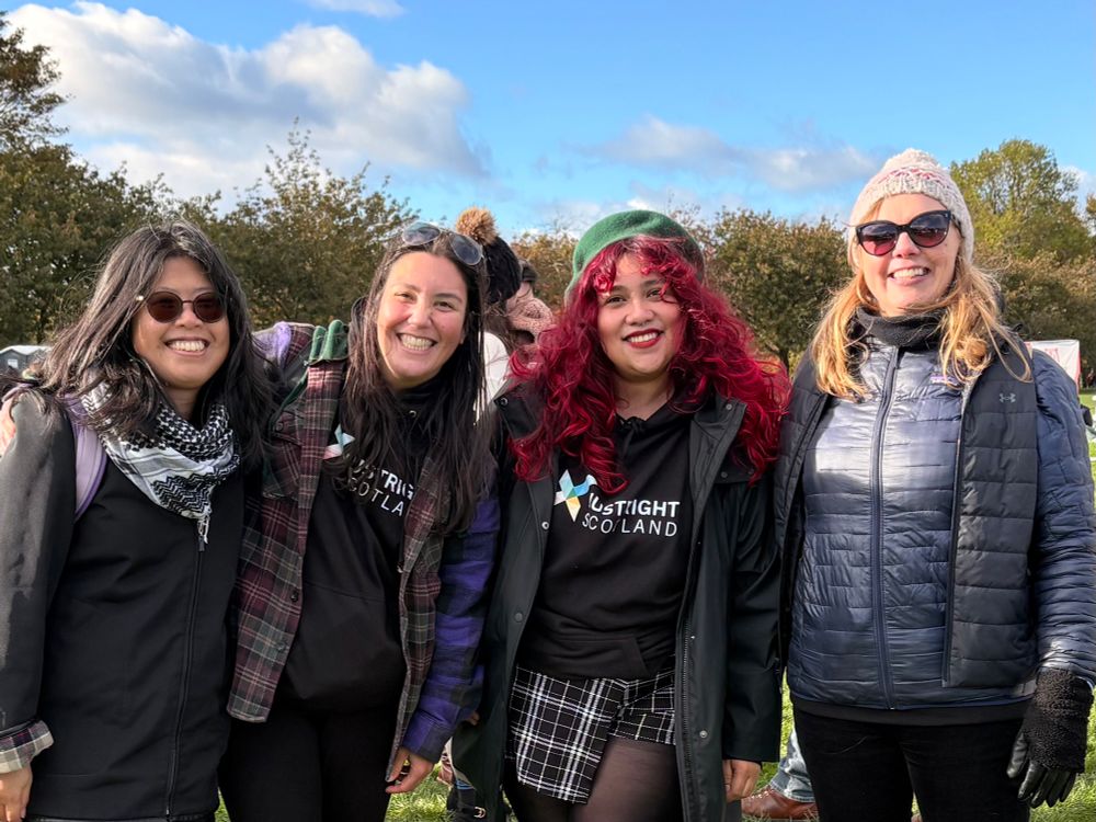 Four smiling friends after protest 