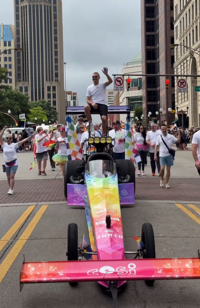 COSI sponsored NHRA drag race car with driver Travis Shumake wrapped in rainbow colors for Columbus Ohio Pride.